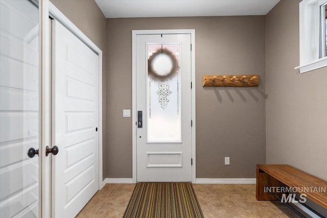 entryway with light tile patterned flooring