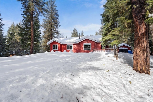 view of front of property with a garage, an outbuilding, and a wooden deck