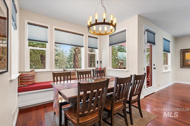 dining room featuring dark hardwood / wood-style flooring and an inviting chandelier