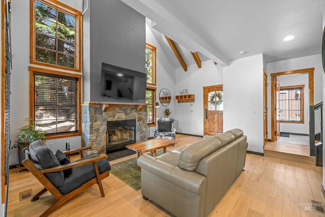 7 Golden Bench Ct, Donnelly, ID 83615 - living room featuring high vaulted ceiling, a fireplace, beam ceiling, light wood finished floors, and healthy amount of natural light