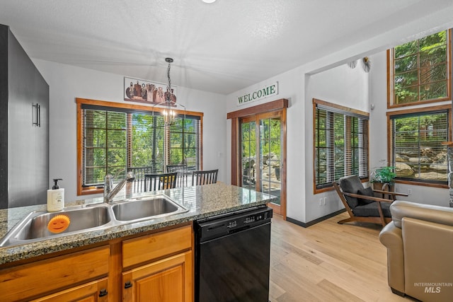 7 Golden Bench Ct, Donnelly, ID 83615 - kitchen featuring black dishwasher, light wood-style flooring, decorative light fixtures, brown cabinets, and a chandelier