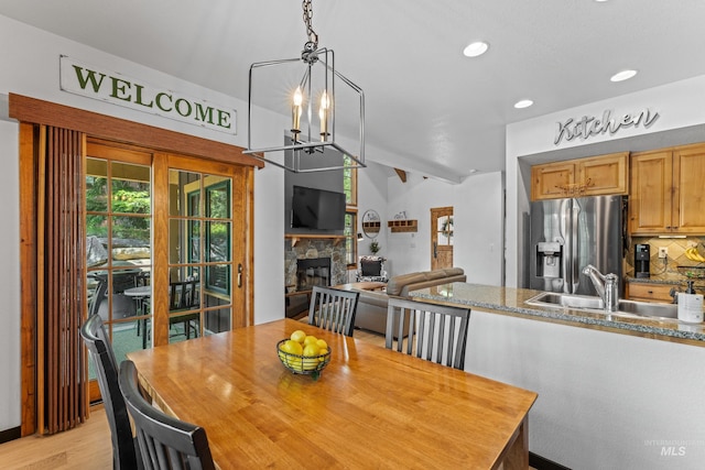 7 Golden Bench Ct, Donnelly, ID 83615 - dining area featuring a chandelier, a fireplace, light wood finished floors, recessed lighting, and vaulted ceiling
