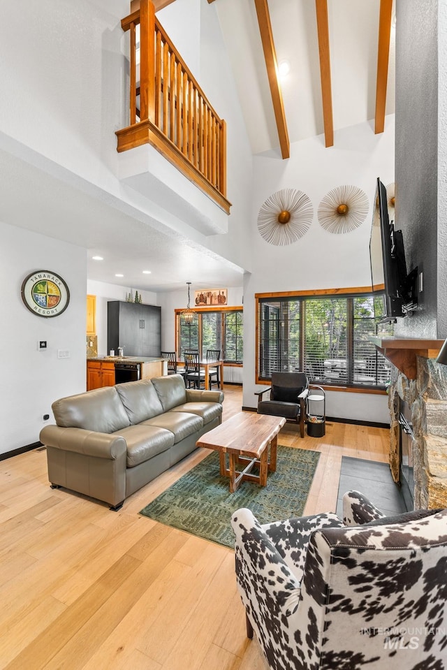 7 Golden Bench Ct, Donnelly, ID 83615 - living room with light wood finished floors, high vaulted ceiling, a fireplace, and beamed ceiling