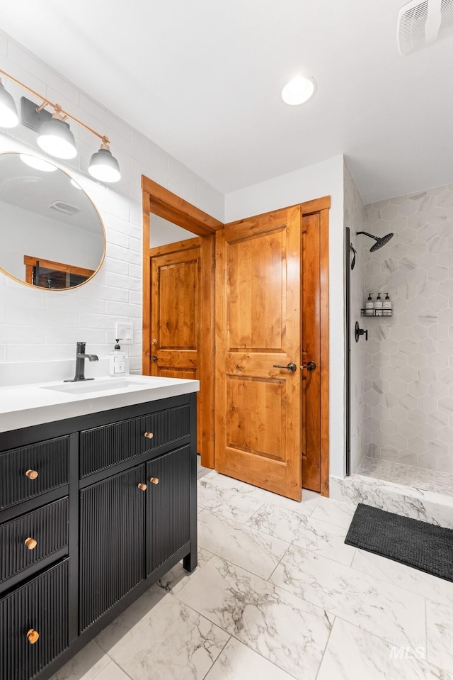 7 Golden Bench Ct, Donnelly, ID 83615 - full bath featuring vanity, a tile shower, marble finish flooring, and tasteful backsplash