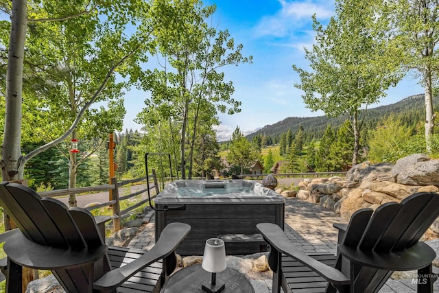 7 Golden Bench Ct, Donnelly, ID 83615 - wooden terrace featuring a hot tub and a mountain view