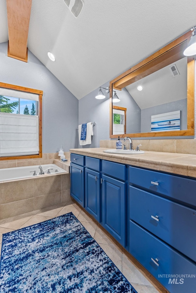 7 Golden Bench Ct, Donnelly, ID 83615 - bathroom featuring vaulted ceiling, vanity, tile patterned flooring, and a bath