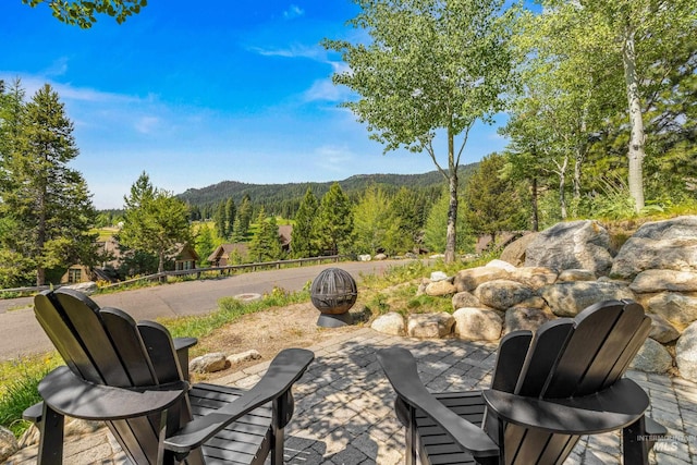 7 Golden Bench Ct, Donnelly, ID 83615 - view of patio / terrace featuring a wooded view and a mountain view