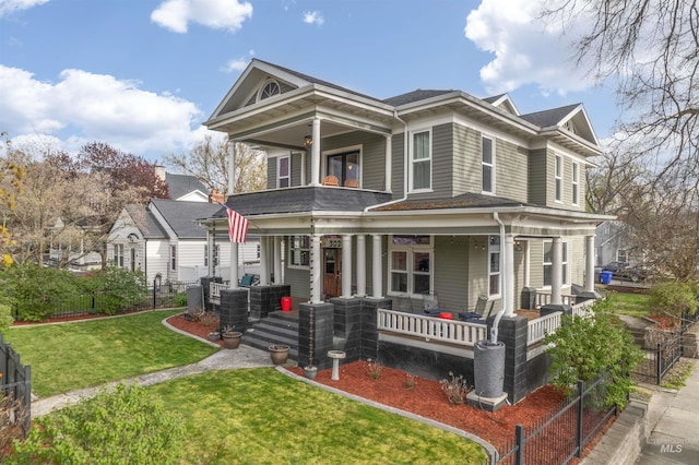 view of front of property featuring covered porch and a front yard