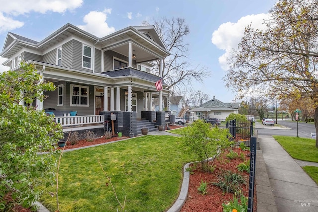 view of front of property featuring a front lawn and a porch