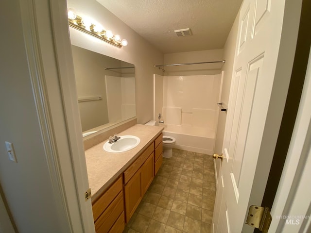 full bathroom featuring vanity, shower / tub combination, toilet, a textured ceiling, and tile patterned flooring