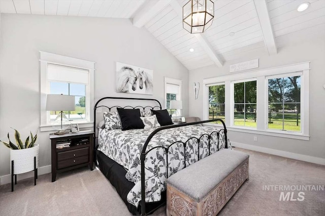 bedroom with lofted ceiling with beams and carpet