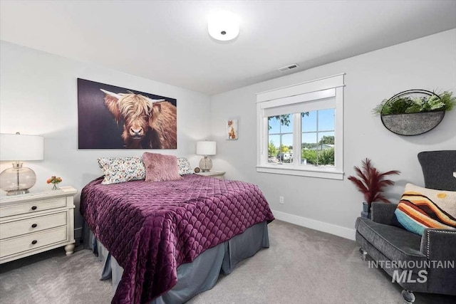 bedroom featuring light carpet