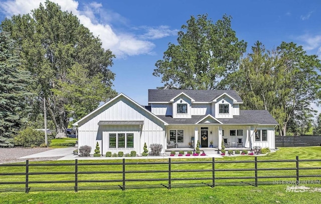 modern inspired farmhouse with covered porch and a front lawn