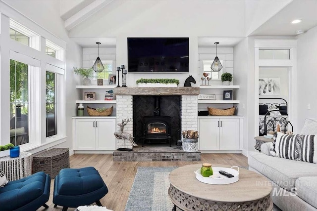 living room featuring vaulted ceiling and light wood-type flooring