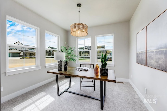 carpeted office featuring baseboards and a chandelier