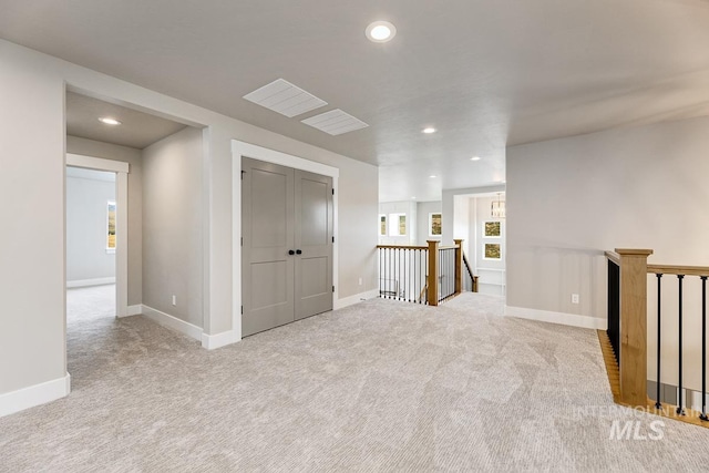 carpeted empty room featuring baseboards and recessed lighting