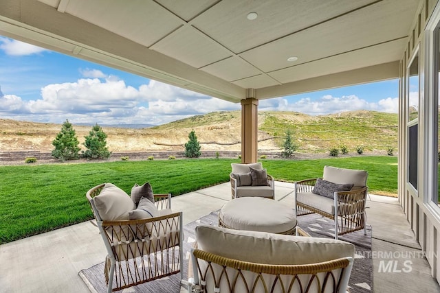 view of patio / terrace with a mountain view and an outdoor hangout area