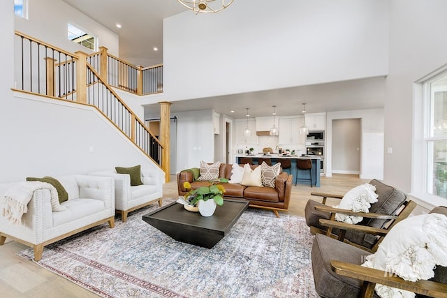 living area featuring recessed lighting, stairs, and a high ceiling