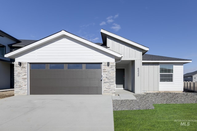 7308 E Marble Springs Dr, Nampa, ID 83687 - view of front of house with a garage, board and batten siding, concrete driveway, and stone siding