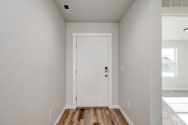 7308 E Marble Springs Dr, Nampa, ID 83687 - doorway with light wood finished floors, visible vents, and baseboards