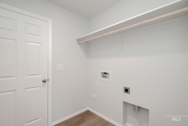 7308 E Marble Springs Dr, Nampa, ID 83687 - washroom with hookup for an electric dryer, baseboards, hookup for a washing machine, wood finished floors, and laundry area