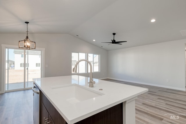 7308 E Marble Springs Dr, Nampa, ID 83687 - kitchen with a sink, open floor plan, light wood finished floors, vaulted ceiling, and decorative light fixtures