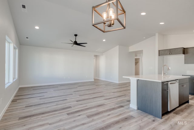 7308 E Marble Springs Dr, Nampa, ID 83687 - kitchen featuring an island with sink, light wood-style floors, light countertops, visible vents, and lofted ceiling