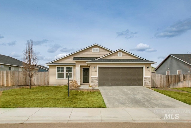 craftsman-style house with a front lawn, stone siding, fence, concrete driveway, and an attached garage