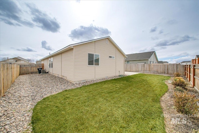 view of home's exterior featuring crawl space, a lawn, central AC unit, and a fenced backyard