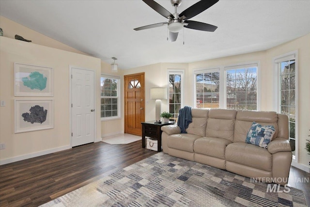 living area featuring ceiling fan, baseboards, and wood finished floors