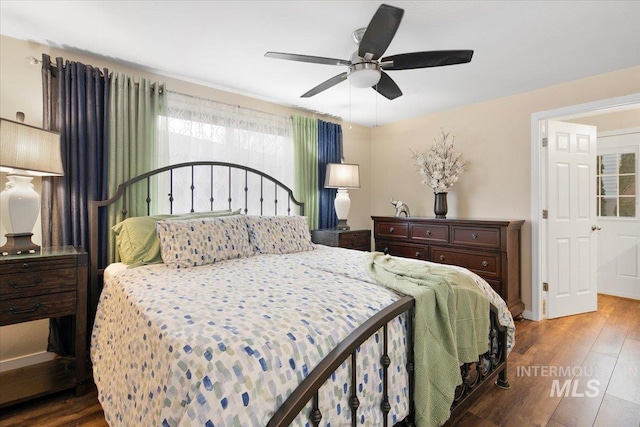 bedroom featuring baseboards, a ceiling fan, and wood finished floors