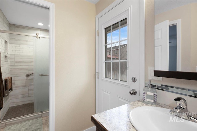 full bath featuring a stall shower and vanity