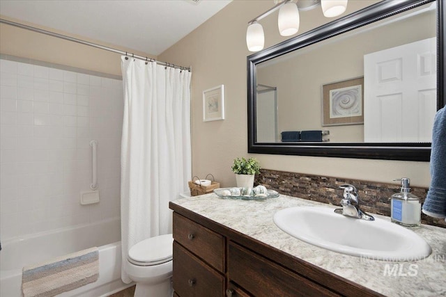 full bathroom featuring toilet, shower / tub combo with curtain, and vanity