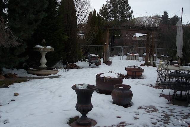 yard covered in snow with fence