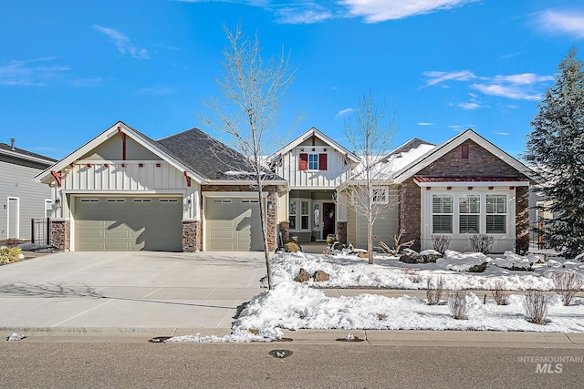 craftsman-style home with a garage, board and batten siding, and concrete driveway