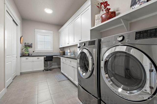 1102 N Longhorn Ave, Eagle, ID 83616 - washroom with light tile patterned floors, a sink, washing machine and dryer, and cabinet space