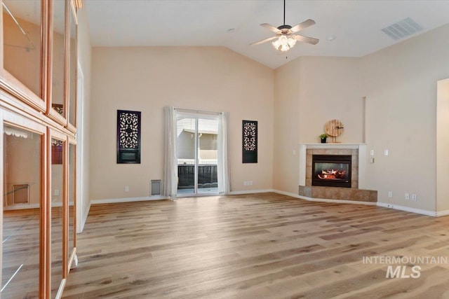 626 N Sterling, Nampa, ID 83651 - unfurnished living room with ceiling fan, high vaulted ceiling, light wood-style floors, and baseboards