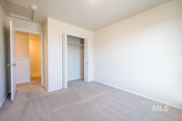 13513 Palm Bch, Caldwell, ID 83607 - unfurnished bedroom with carpet floors, attic access, and a closet