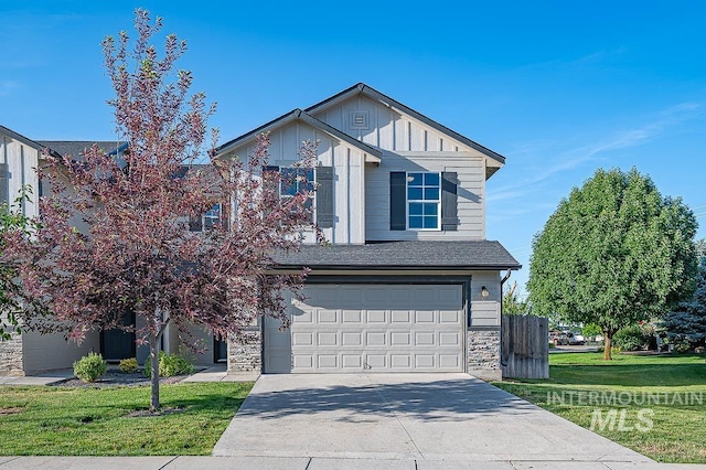 13513 Palm Bch, Caldwell, ID 83607 - view of front of home with an attached garage, driveway, board and batten siding, and stone siding