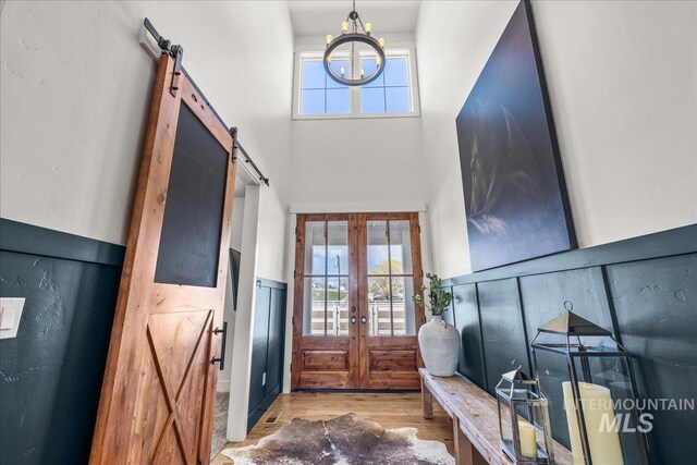 10935 Purple Sage Rd, Middleton, ID 83644 - foyer with a barn door, a high ceiling, plenty of natural light, and a chandelier