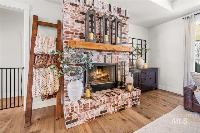 10935 Purple Sage Rd, Middleton, ID 83644 - living room featuring a fireplace, visible vents, wood finished floors, and baseboards
