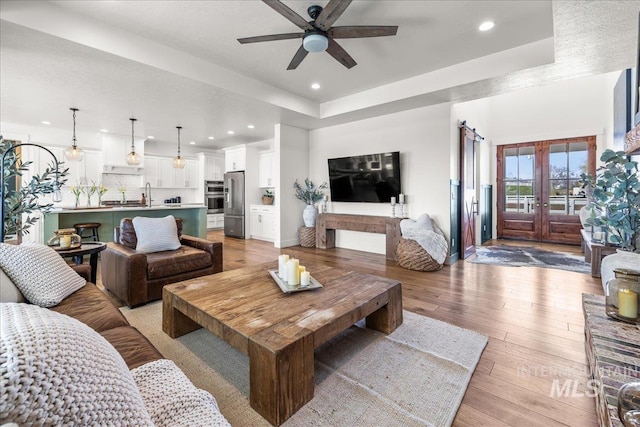 10935 Purple Sage Rd, Middleton, ID 83644 - living area featuring recessed lighting, light wood-style flooring, a tray ceiling, and ceiling fan