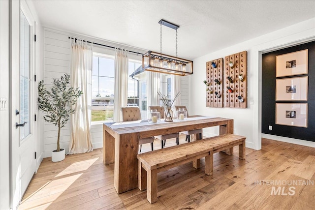 10935 Purple Sage Rd, Middleton, ID 83644 - dining room with light wood finished floors, a textured ceiling, and baseboards