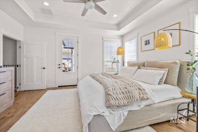 10935 Purple Sage Rd, Middleton, ID 83644 - bedroom featuring a tray ceiling, recessed lighting, visible vents, and light wood-type flooring
