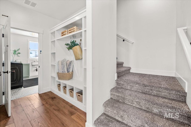 10935 Purple Sage Rd, Middleton, ID 83644 - mudroom featuring hardwood / wood-style flooring, built in shelves, baseboards, and visible vents