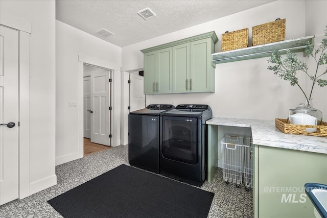 10935 Purple Sage Rd, Middleton, ID 83644 - laundry area featuring washer and clothes dryer, visible vents, cabinet space, and a textured ceiling