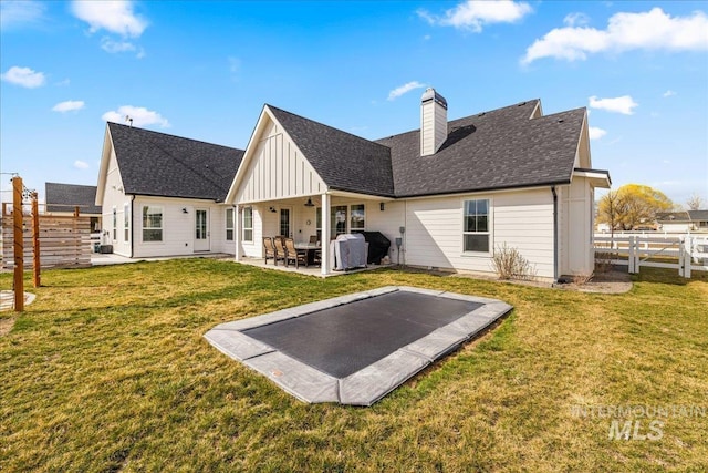 10935 Purple Sage Rd, Middleton, ID 83644 - back of house featuring a yard, roof with shingles, a fenced backyard, and a patio area