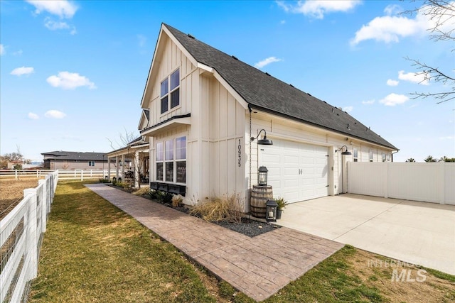 10935 Purple Sage Rd, Middleton, ID 83644 - view of side of property with a lawn, driveway, fence, roof with shingles, and board and batten siding
