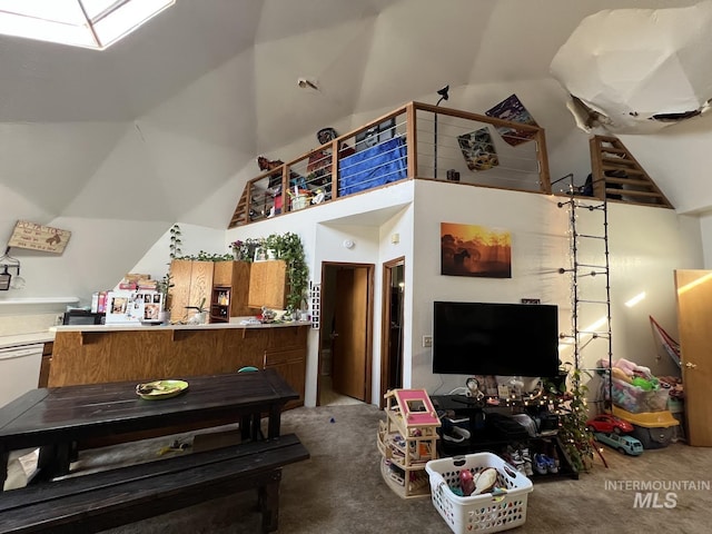 carpeted living area with high vaulted ceiling