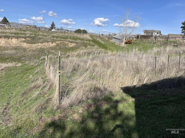 exterior space featuring a rural view and fence